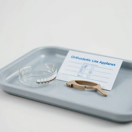 Clear aligner and braces components arranged on a clinic tray for orthodontic treatment solutions
